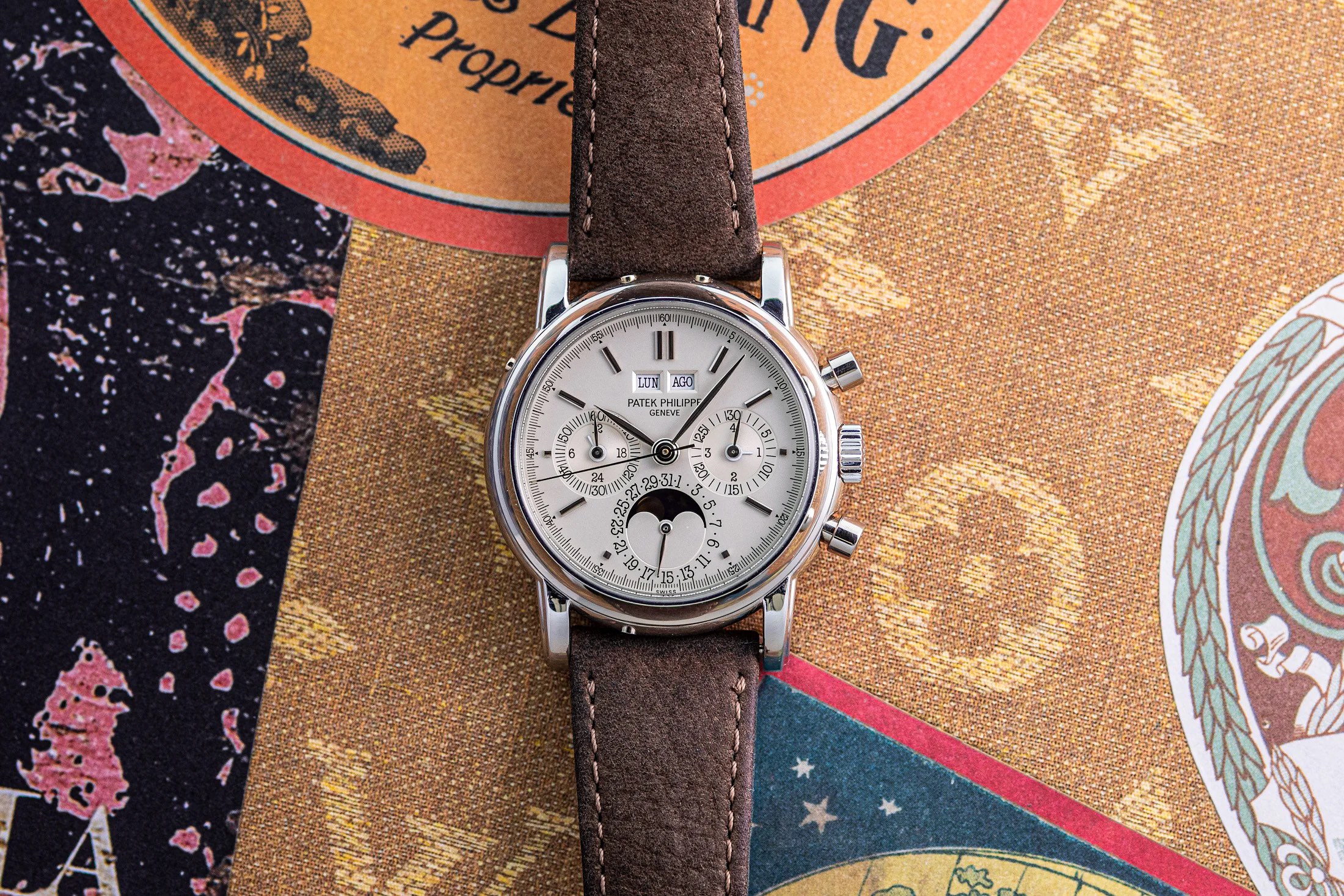 Patek Philippe perpetual calendar chronograph watch on an ornate background