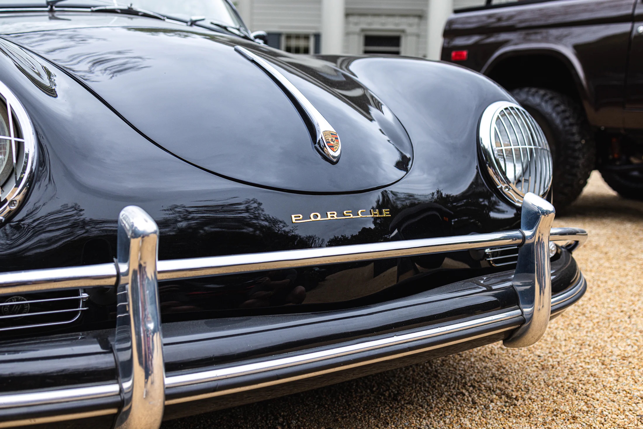 Close up of the headlights and front bumper of a porsche speedsteer