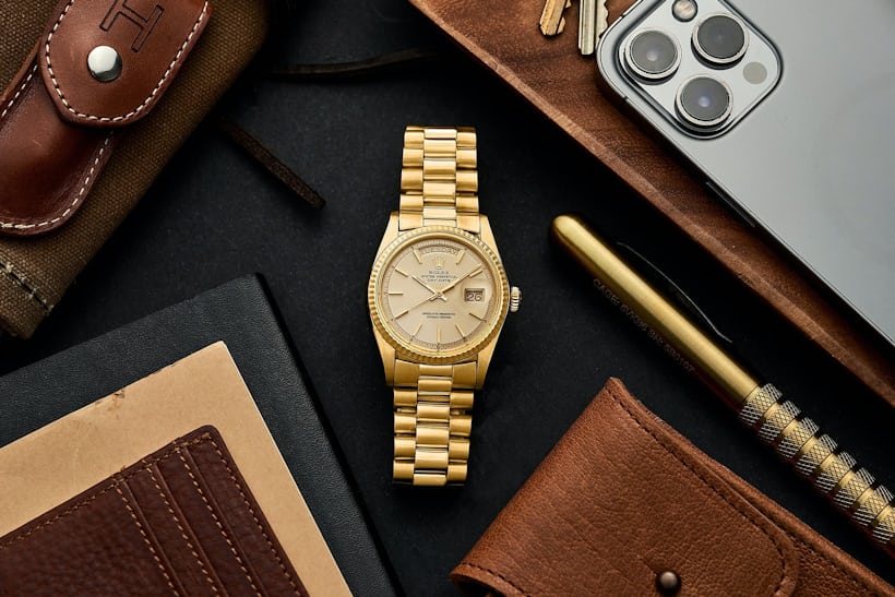 A yellow-gold Rolex Day-Date.