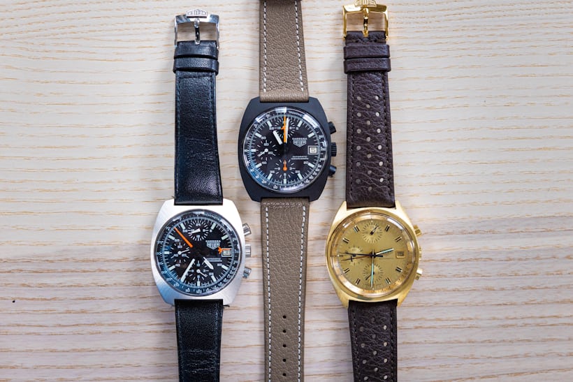 Three carrera watches laid out on a wooden surface