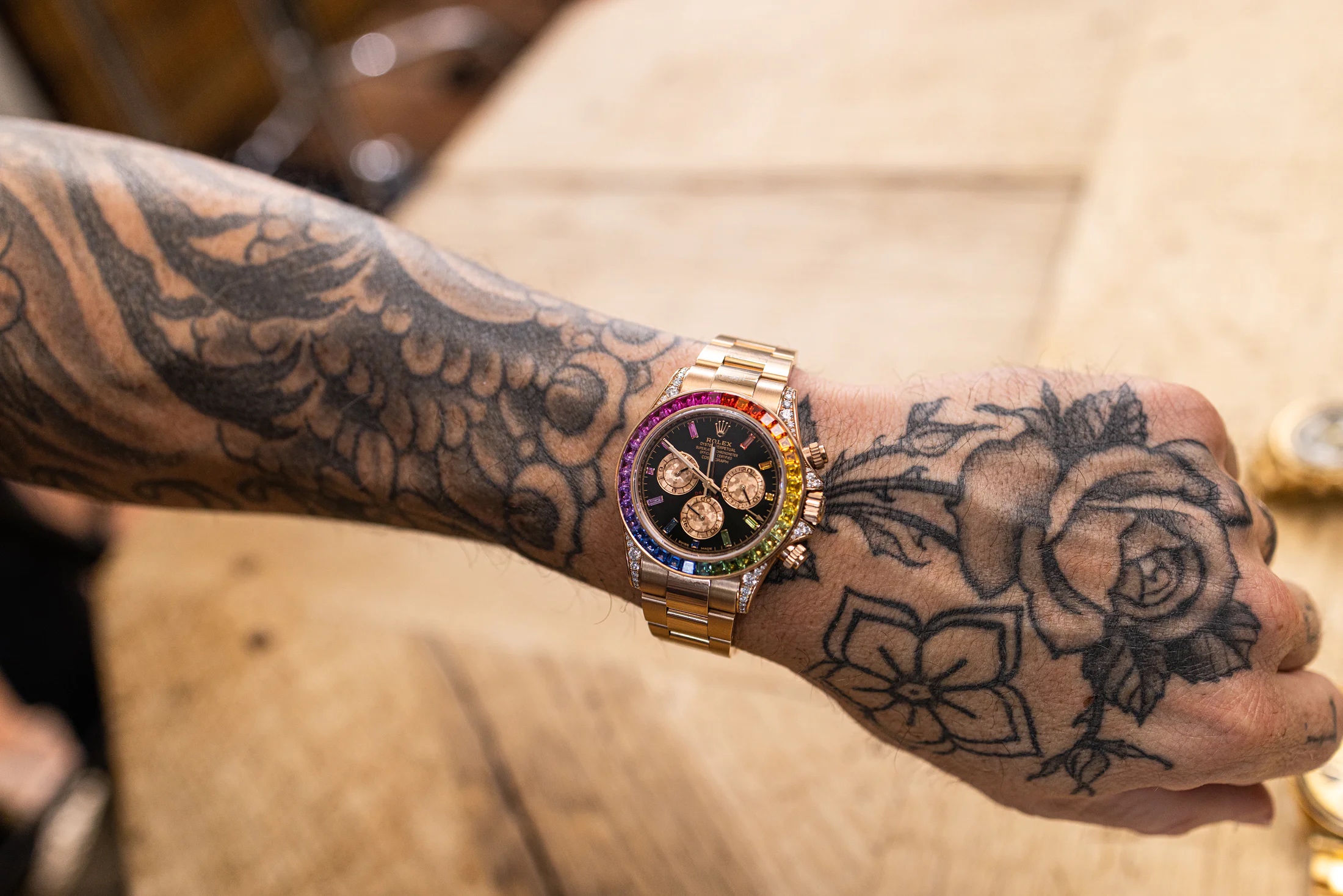 Wrist shot of a rose gold rainbow rolex daytona