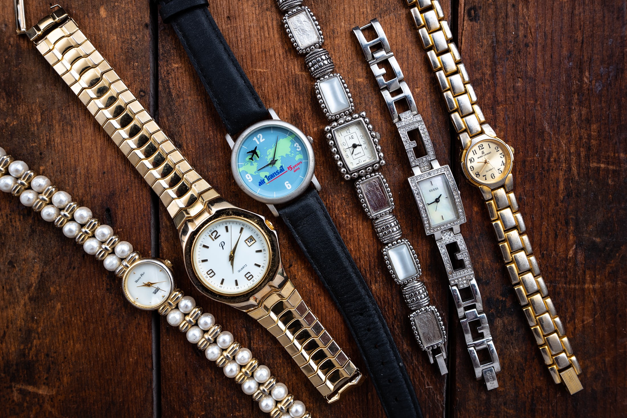 Several more inexpensive watches on a table. 