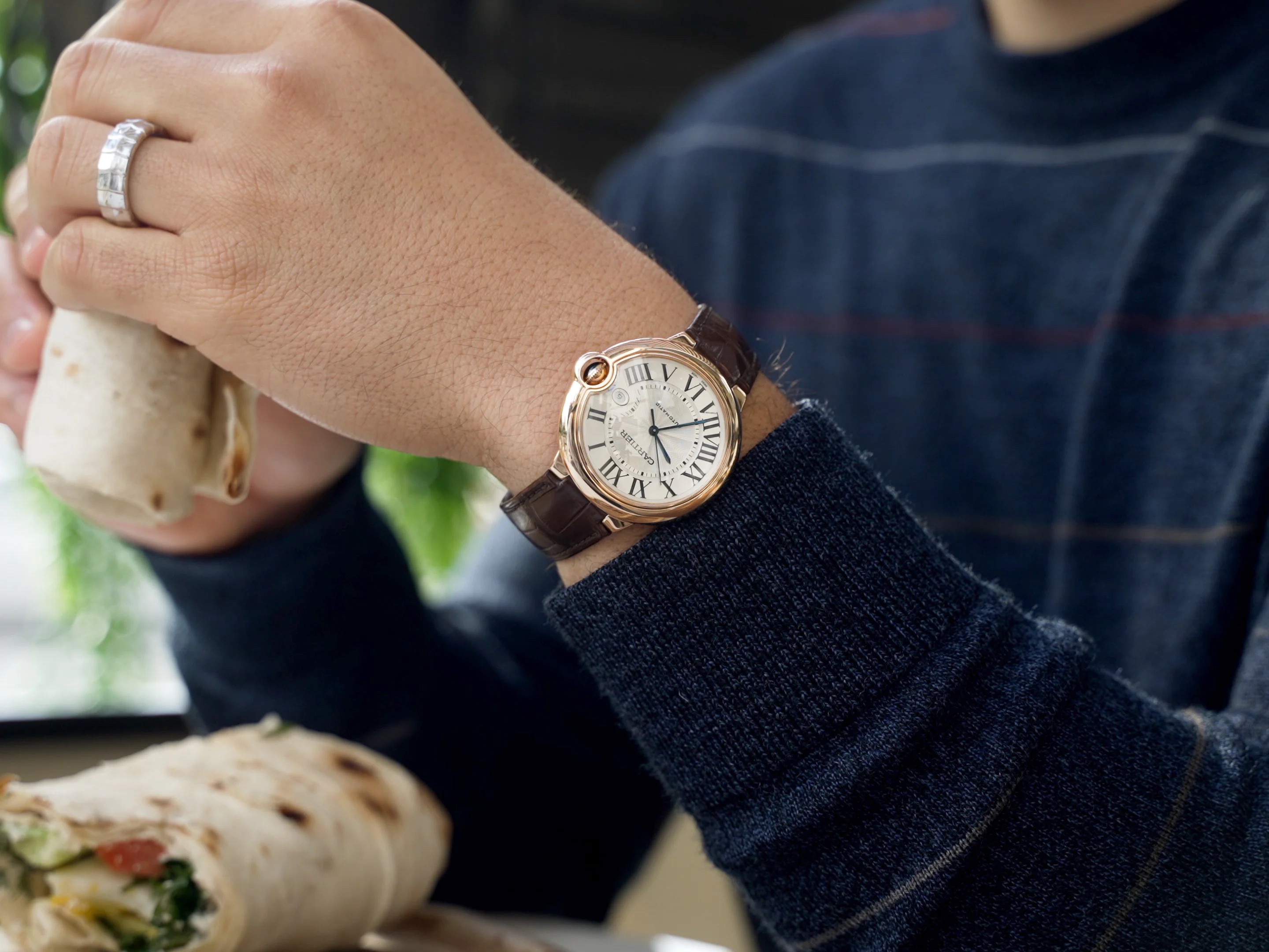 holding a wrap while wearing a gold watch