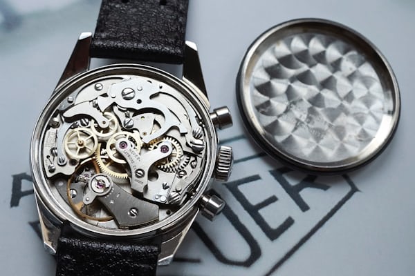 Open caseback of a Heuer ref 7753 displaying the caliber valjoux 7730