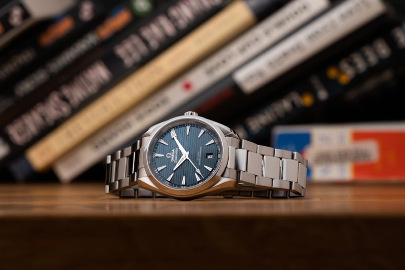 watch on desk with books in background