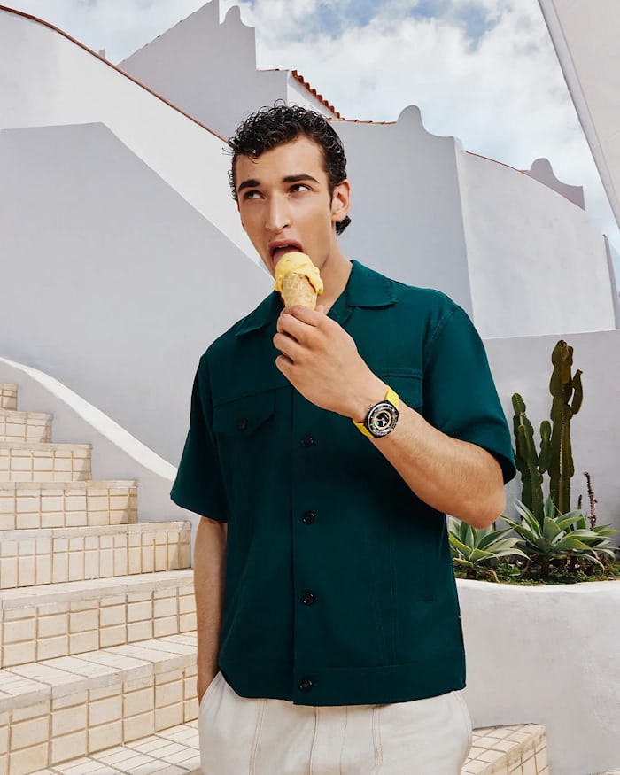 Man eating ice cream, wearing a watch