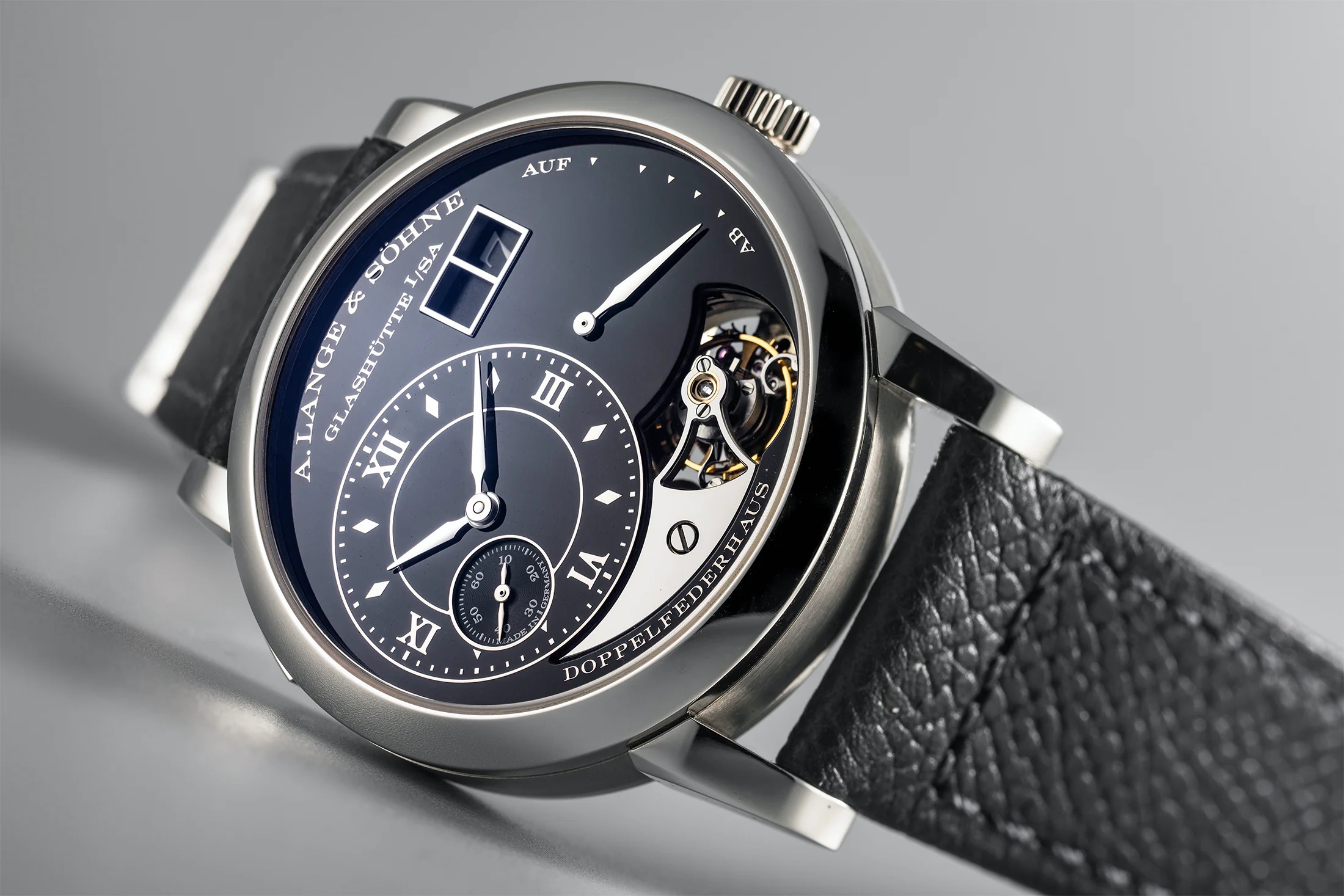 A. Lange & Söhne Reference 704.048 Lange, extremely rare, platinum tourbillon watch with large date display, limited edition of 20 pieces, serial number 16, to commemorate the twentieth anniversary of the release of "Lange 1". With warranty and watch box