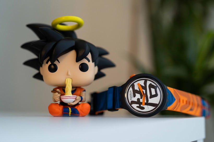 Goku figure and watch on desk 