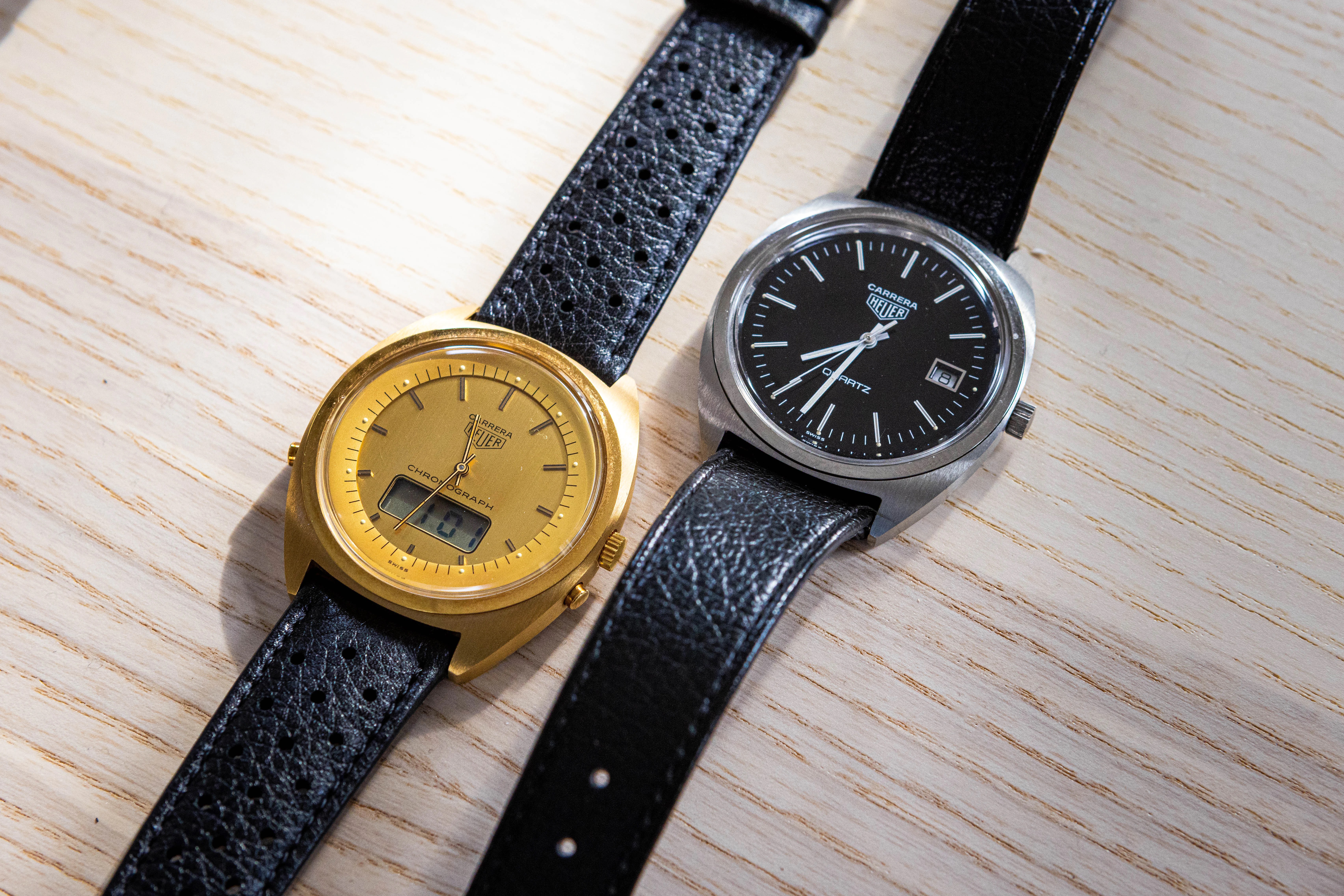 Two quartz carreras laid out on a wooden surface